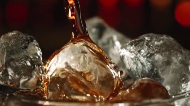 Super Slow Motion Shot of Pouring Fresh Cola Lemonade on Ice Cubes With Camera Motion at 1000fps. Filmed with High Speed Cinema Camera, 4k.