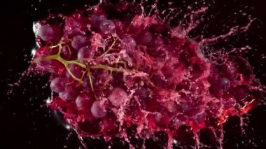 Super Slow Motion Shot of Fresh Grape Falling into Red Wine on Black Background at 1000 fps. Filmed with High Speed Cinema Camera in 4K.