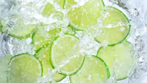 Super Slow Motion Shot Fresh Lime Slices Falling Water Whirl — Stock Video