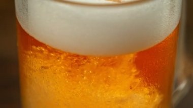Super Slow Motion Detail Shot of Pouring Beer with Camera Motion Sliding Down at 1000fps. Filmed with High Speed Cinema Camera in 4K.