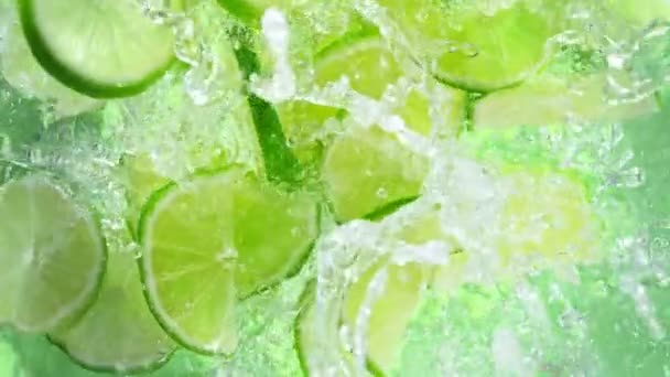 Super Slow Motion Shot Fresh Lime Slices Falling Water Whirl — Stock Video