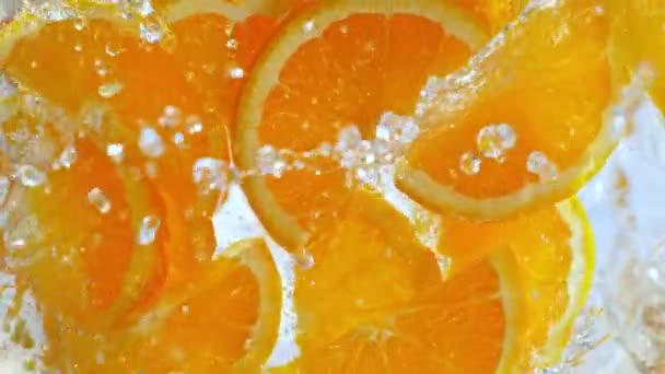 Super Slow Motion Shot Fresh Orange Slices Falling Water Whirl — Stock Video