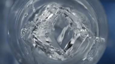 Süper Yavaş Hareket Detaylı Buz Küpünün 1000 fps 'lik votkayla bardağa düşüşü. 4K 'da Yüksek Hız Sinema Kamerası ile çekildi.