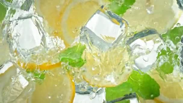 Сверхмедленная Движущаяся Струя Воды Плещется Лимонных Слайсах Кубиках Льда Листьях — стоковое видео