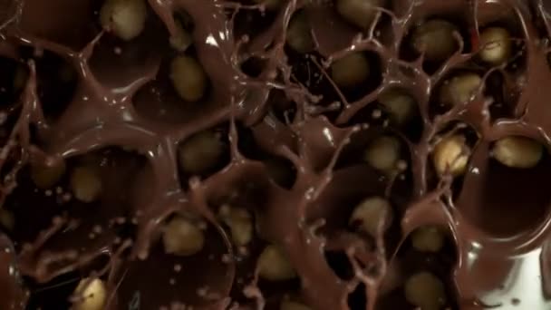 Super Slow Motion Shot Peeled Hazelnuts Falling Swirling Melted Chocolate — Video Stock
