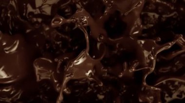 Su Sıçratma 'nın Süper Yavaş Çekimi Eritilmiş Çikolata Arka planı, 1000 fps' de. Yüksek Hız Sinema Kamerası, 4K.