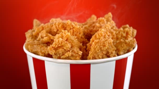 Slow Motion Shot Fried Chicken Bites Smoke Rotating Bucket Red — Vídeo de Stock
