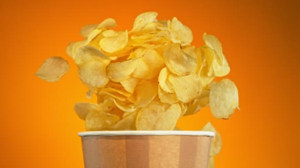 Super Slow Motion Shot Potato Chips Flying Bucket Golden Background — Vídeos de Stock