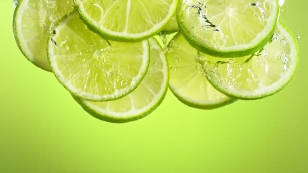 Super Slow Motion Shot Fresh Lime Slices Falling Flowing Water — Stock Video