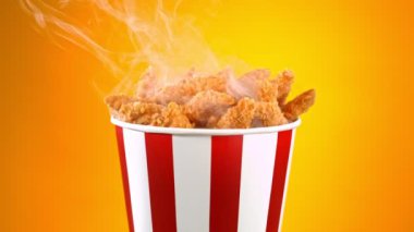 Slow Motion shot of Fried Chicken Pieces ve Smoke Rotting in a Bucket on Golden Background. Yüksek Hız Sinema Kamerası, 4K.