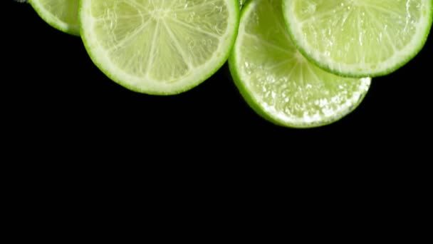 Super Slow Motion Shot Fresh Lime Slices Falling Flowing Water — Wideo stockowe
