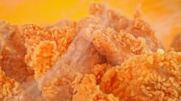 Slow Motion Shot Fried Chicken Pieces Smoke Rotating Golden Background — Wideo stockowe