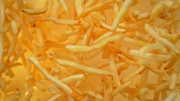 Super Slow Motion Shot French Fries Flying Camera Golden Background — Stock video
