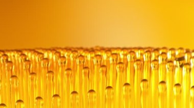 Altın Arkaplanda Uçan Yağ Damlalarının Süper Yavaş Çekimi, 1000fps 'de. Yüksek Hız Sinema Kamerası, 4K.