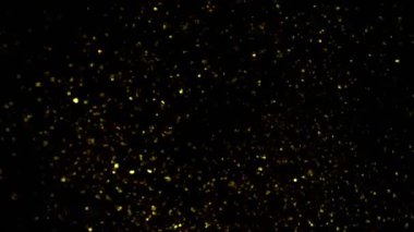 Süper Yavaş Çekim Altın Parıldayan Parçacıklar. Siyah üzerine izole edilmiş ve yüksek hızlı sinema kamerasıyla çekilmiş, 4K.