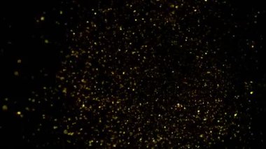 Süper Yavaş Çekim Altın Parıldayan Parçacıklar. Siyah üzerine izole edilmiş ve yüksek hızlı sinema kamerasıyla çekilmiş, 4K.