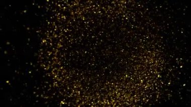 Süper Yavaş Çekim Altın Parıldayan Parçacıklar. Siyah üzerine izole edilmiş ve yüksek hızlı sinema kamerasıyla çekilmiş, 4K.