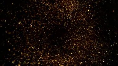 Süper Yavaş Çekim Altın Parıldayan Parçacıklar. Siyah üzerine izole edilmiş ve yüksek hızlı sinema kamerasıyla çekilmiş, 4K.