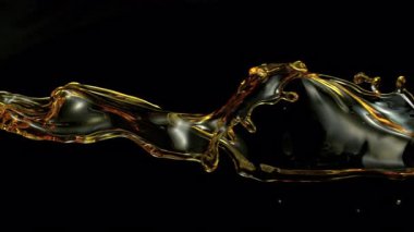 Ultra Slow Motion Golden Oil Splash, Sıvı Dalgalar Siyah Arkaplanda Yüksek Hız Sinema Kamerası, 4K.