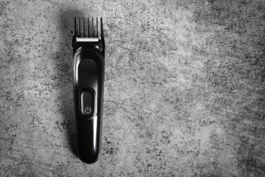 Electric shave machine on grey background. Electric shaver top view with copy space.