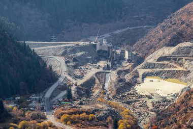 Top view on construction of a mudflow protection dam in the Big Almaty Gorge in the mountains of Almaty. Almaty, Kazakhstan - October 25, 2022