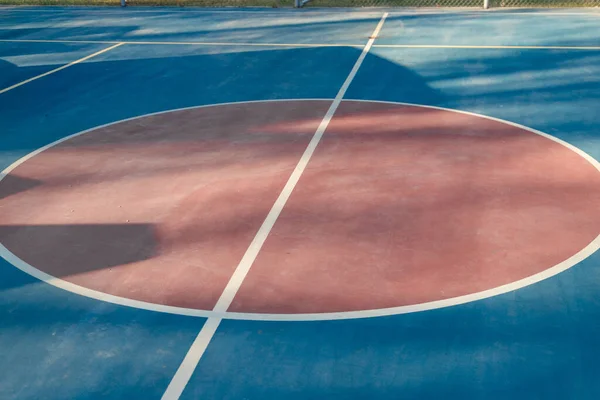 Blue floor of sports court with marking lines.