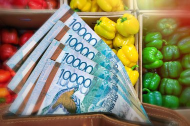 Kazakistan 'da sebze ve tarım ürünlerinin fiyatları yükseliyor. Bir cüzdanda, bir tezgahın arka planında dolmalık biberli onluk..