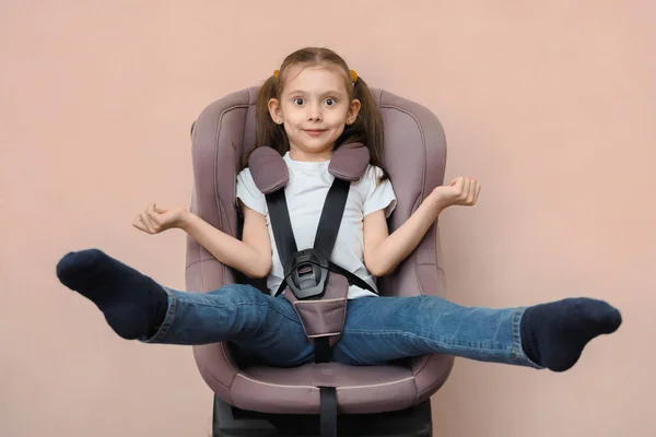 When is it time to change your child car seat. Funny little girl grew out of her car seat.