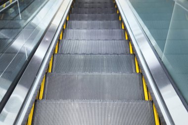 Top view on steps of escalator modern buildings or subway station. clipart