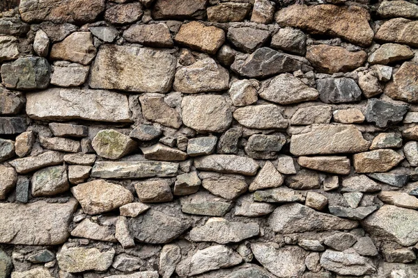 stock image Old background of natural stones wall of different sizes.