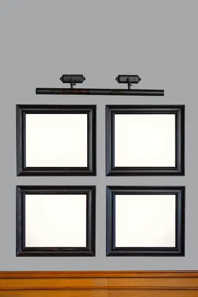 Template with four frames for a painting or photograph on gray wall, copy space, vertical.