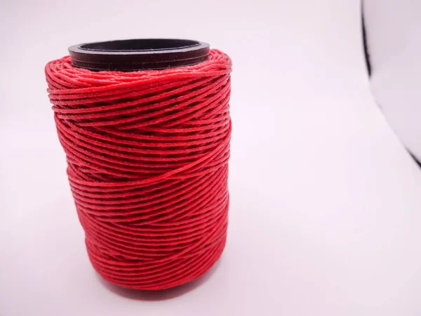 Red thread on white background. Roll red rope. fashion designer tools