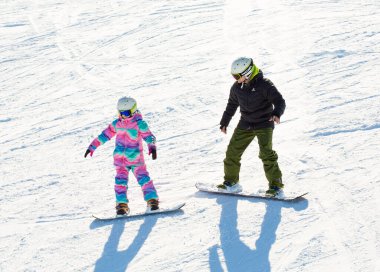Bialka Tatrzanska, Poland - February 9, 2023: Kotelnica Ski Station in the Tatra Mountains. Tourists and downhill skiing. Equipment for the preparation of the ski slope. Traditional buildings