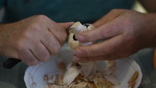 Man Sitting Table Cleaning Champignon Mushrooms Knife Removing Top Film — Stock Video