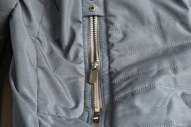 Close-up of a zipper sewn into a jacket pocket.
