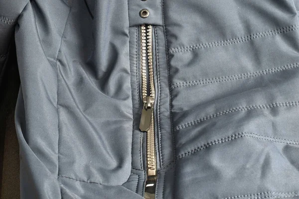 Close-up of a zipper sewn into a jacket pocket.