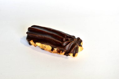 Eclair cake baked from choux pastry and covered with chocolate on a white background.