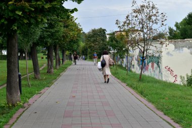 Tambov. Tambov Region. Russia. 09/08/2021. City Park. A woman walks along a path in the park.
