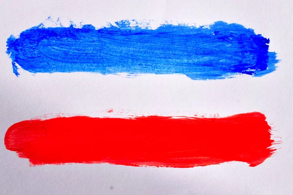 White, blue and red lines painted with watercolors on a white background similar to the flag of Serbia and Montenegro.