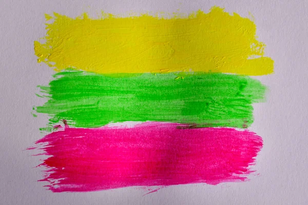 Yellow, green and red lines painted with watercolors on a white background similar to the flag of Lithuania.