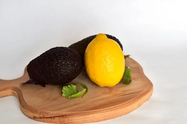 Two Avocados One Lemon Cutting Board — Stock Photo, Image