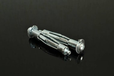 Birkaç çapa parçası, gümüş, yakın plan, koyu bir arka planda yatıyor..