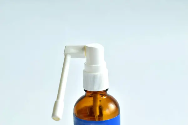 Stock image A bottle with an aerosol for applying medicine to the throat.