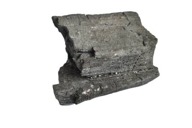 Ayrı bir kömür parçası beyaz, yakın plan üzerinde uzanıyor..