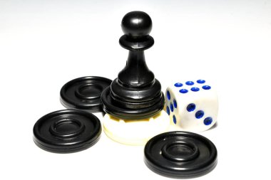 Chess pieces, checkers and dice lie on a white background. clipart