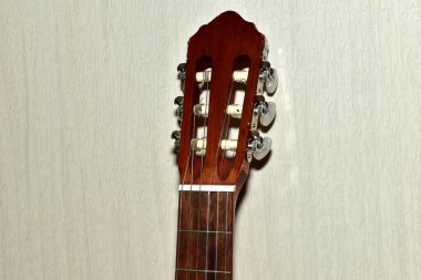 Classical acoustic six-string guitar. Headstock with tuning pegs. clipart