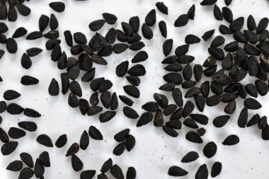 Black cumin seeds aromatic spice on white background, top view. clipart