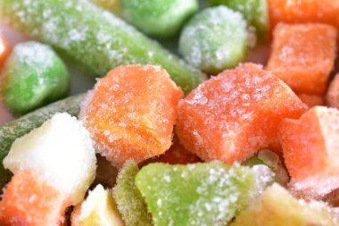 A mixture of finely chopped and frozen various vegetables.