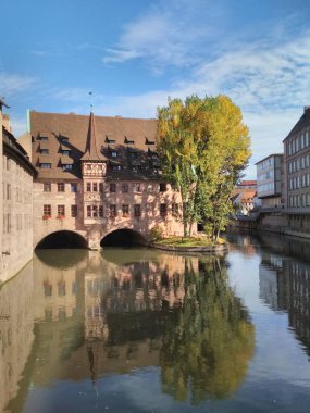 Nuremberg, Germany 10.17.2019 View of Heilig-Geist-Spital from Museumsbrcke in Nuremberg, Germany clipart