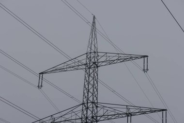 image of an electricity pylon on a bright cloudy day in Germany